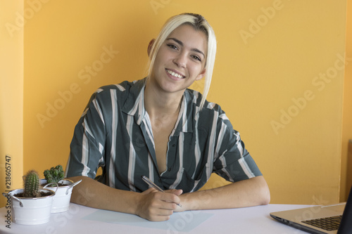 Office worker poses looking at camera photo