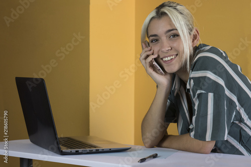 Office worker looking at camera with phone photo