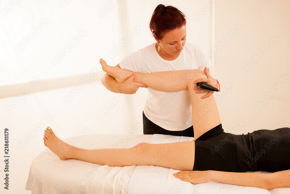 Physiotherapist doing Tecar therapy alterantive treatment on a woman patient Physiotherapist doing Tecar therapy alterantive treatment on a woman patient