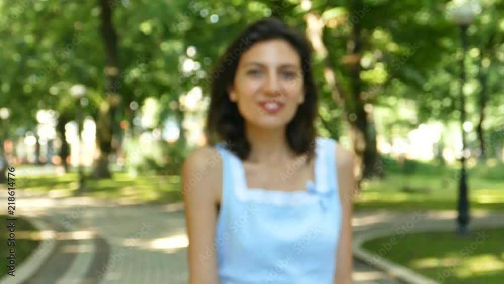            Woman  model dance in summer city park..Approach scene. Slow motion, 