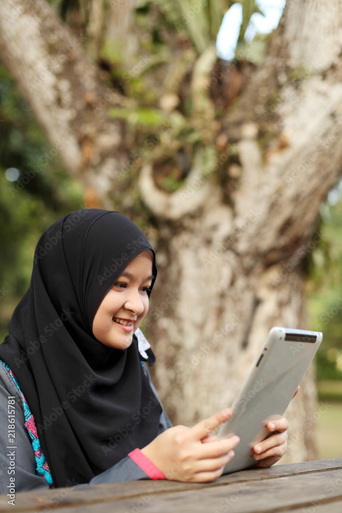 Muslim lady working on smiling Muslim lady working on smiling