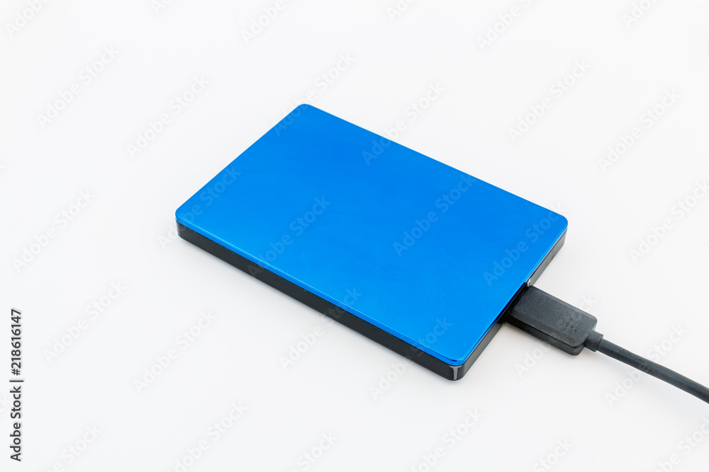 External disk hard drive connected to notebook for backup from computer data on white background External disk hard drive connected to notebook for backup from computer data on white background