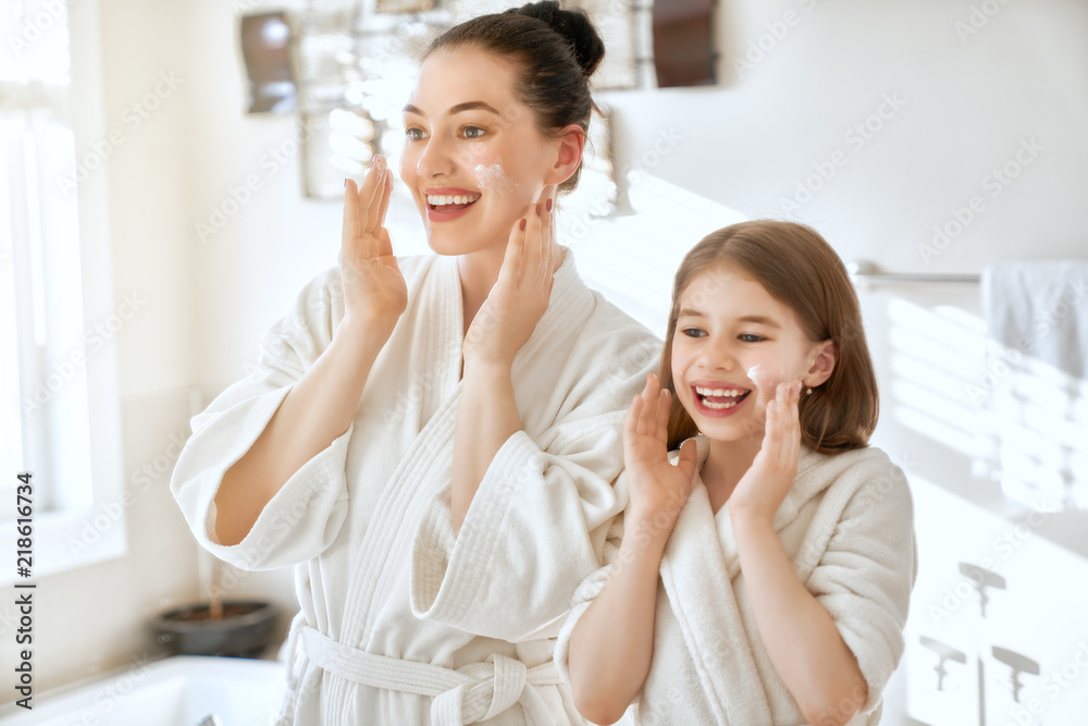 Mother and daughter caring for skin Mother and daughter caring for skin