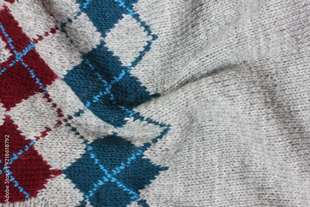 Grey knitted rhombus wool texture background Grey knitted rhombus wool texture background