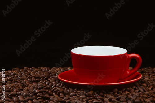 Red coffee cup with coffee beans .