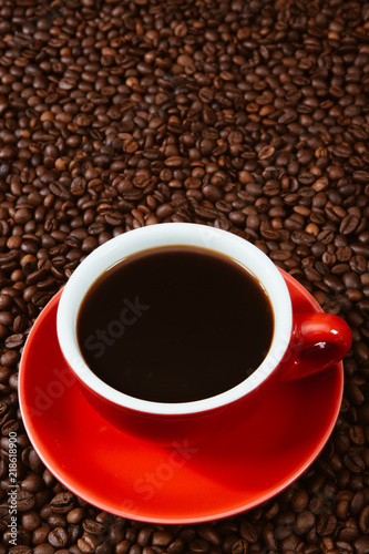 Red coffee cup with coffee beans .
