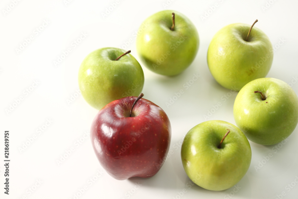 Red apple stand out among green apples Red apple stand out among green apples