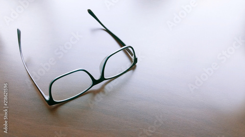 Modern style eyeglasses, spectacles or glasses on solid surface.