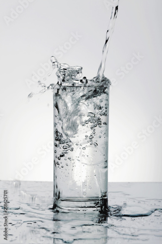 Pouring water into drinking glass