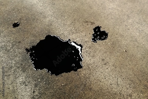 black dirty oil on concrete ground