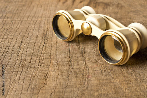 Vintage theatre binoculars on an old wooden table