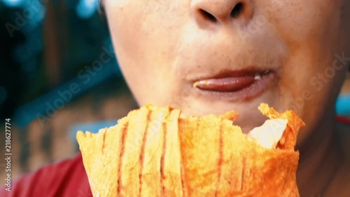 Close-up, woman eats, fast food, doner kebab, pita, shawarma