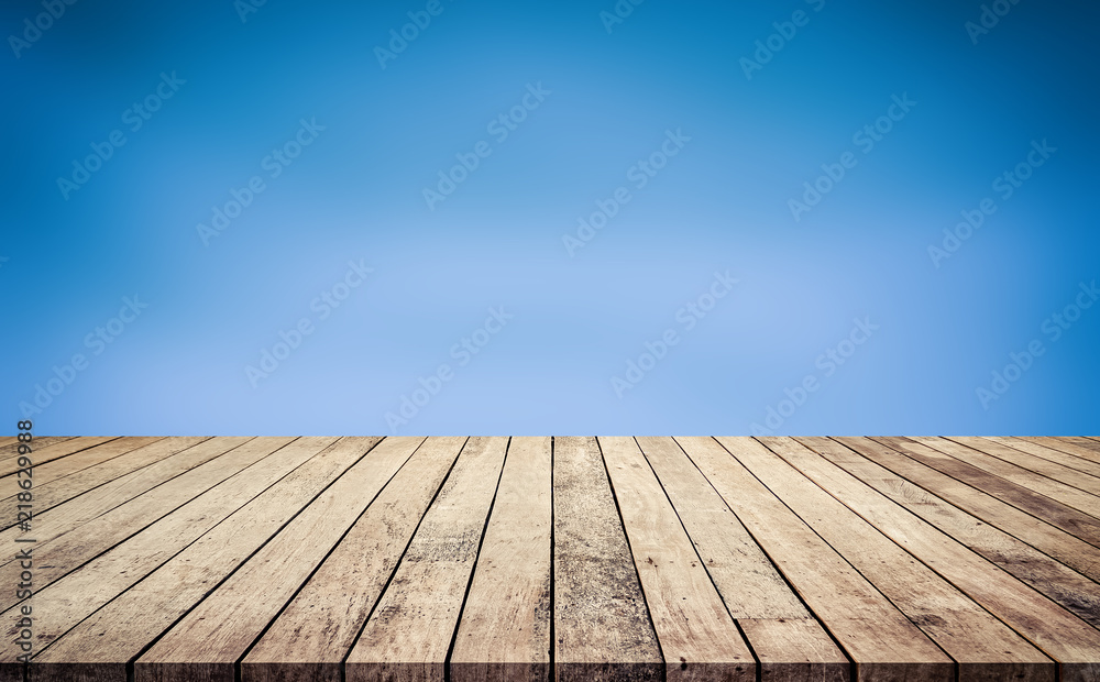 Wood plank with abstract blue blurred background for product display