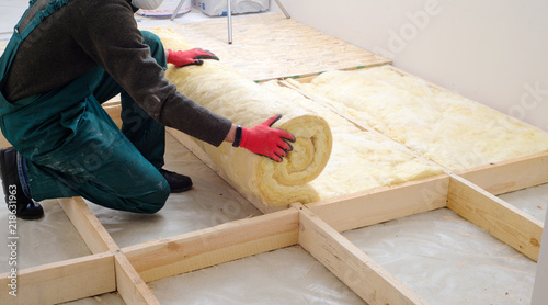 Quadro em tela worker insulates the floor with mineral wool