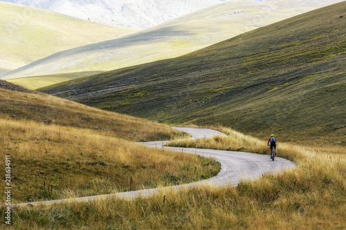 A Isolated Cyclist uphill on a Mountain Road of Campo Imperatore - Abruzzo -Italy