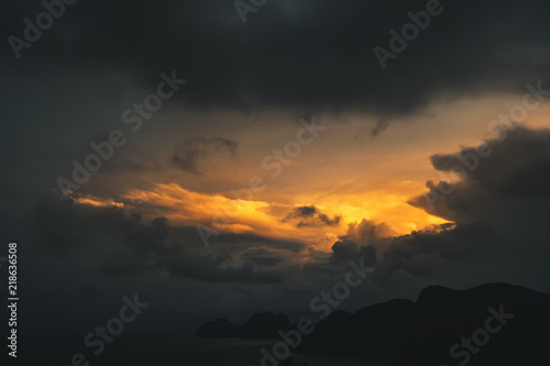 dark dramatic sky during golden yellow sunset on exotic island, thailand © manushot