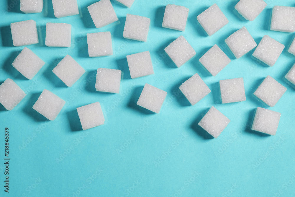 Table top shot Group of Sugar cubes vary position on light blue background Table top shot Group of Sugar cubes vary position on light blue background