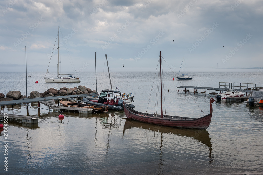View of the harbour of little village. Viking ship in the small harbour. The Gulf of Finland, Estonia. Kasmu (captain's village).