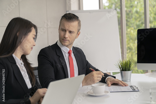 Young business man presented or discuss to client about business project in coference or meeting room. photo