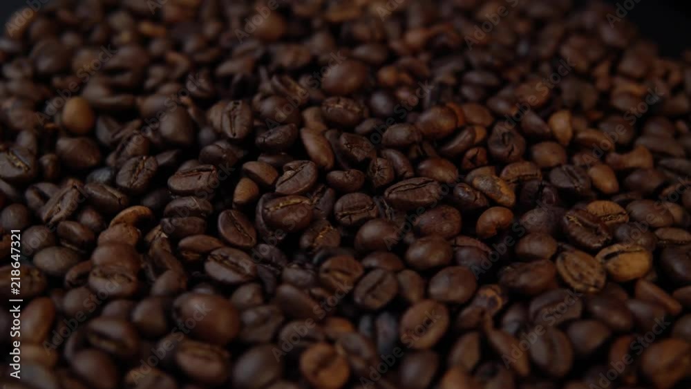 Dark fried beans rotate counter-clockwise, coffee background. Dark fried beans rotate counter-clockwise, coffee background.