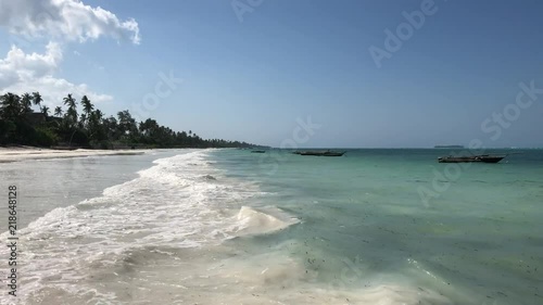 Tropical beach. Palms, sand, ocean, boats. Zanzibar. Tanzania