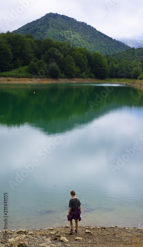 Young girl by the lake Lareo in the natural park of Aralar, Gipuzkoa