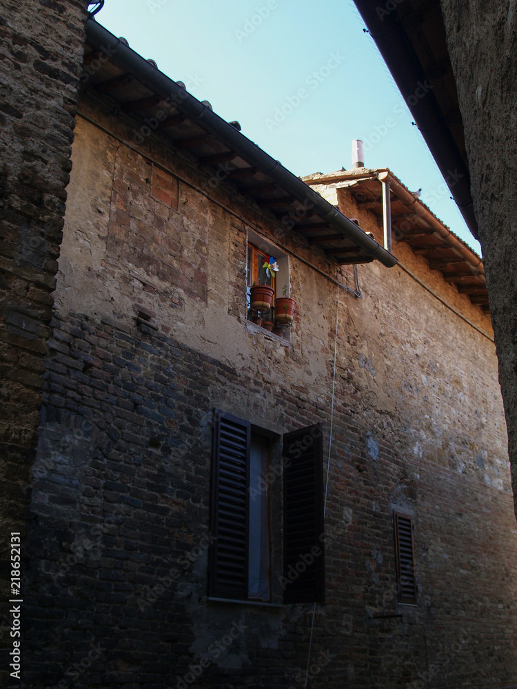 narrow street of san gimignano, tuscany, italy.