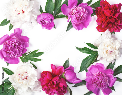 Floral frame made of pink and white peony flowers and leaves isolated on white background. Flat lay. Top view.