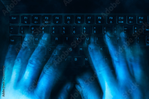 Принти на полотні hands are typing on the keyboard in the dark