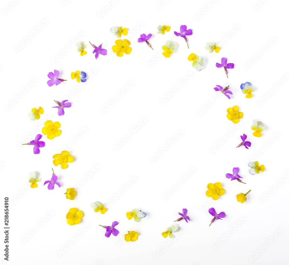 Round frame wreath made of meadow flowers isolated on white background. Top view. Flat lay.