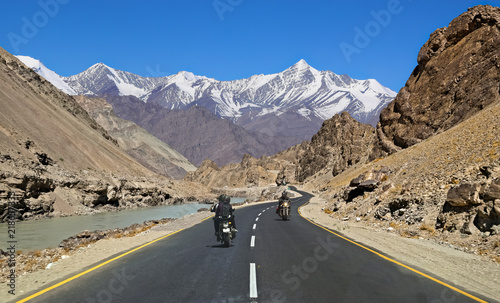 Indian bikers at Ladakh India traveling on national highway road with scenic landscape . photo