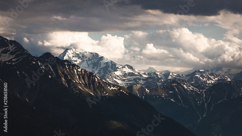 Moody sunset light on mountain and cloudy sky © ezgode