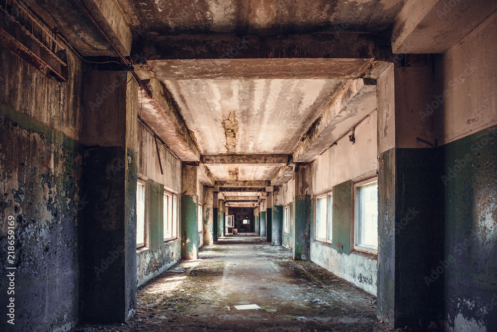 Dirty empty dark corridor in abandoned building, perspective