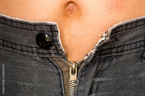 Obraz na plátne A overweight man can't tight his pants because his fats in belly
