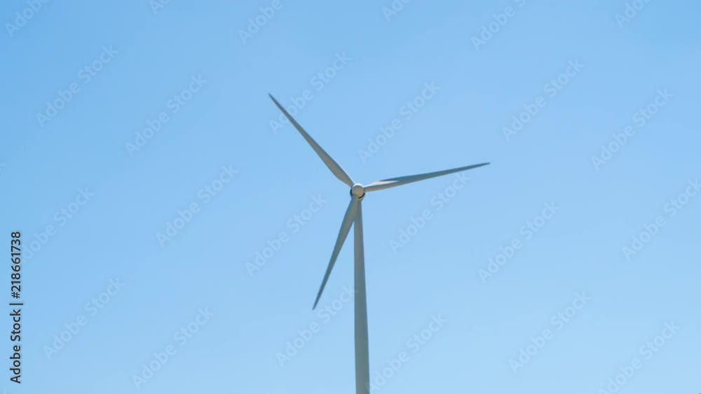 One windmill in Larnaca, Cyprus. Wind power technology - wind turbine against blue sky. Clean and renewable energy resource of alternative energy production One windmill in Larnaca, Cyprus. Wind power technology - wind turbine against blue sky. Clean and renewable energy resource of alternative energy production