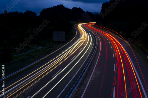 Car lights on a mountain road at dusk