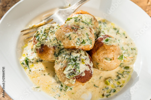 Swedish food - traditional chicken meatballs with cream sauce, top view, close-up