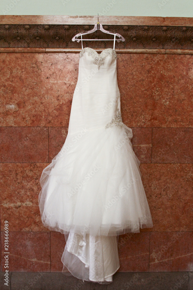 Bridal gown against granite wall