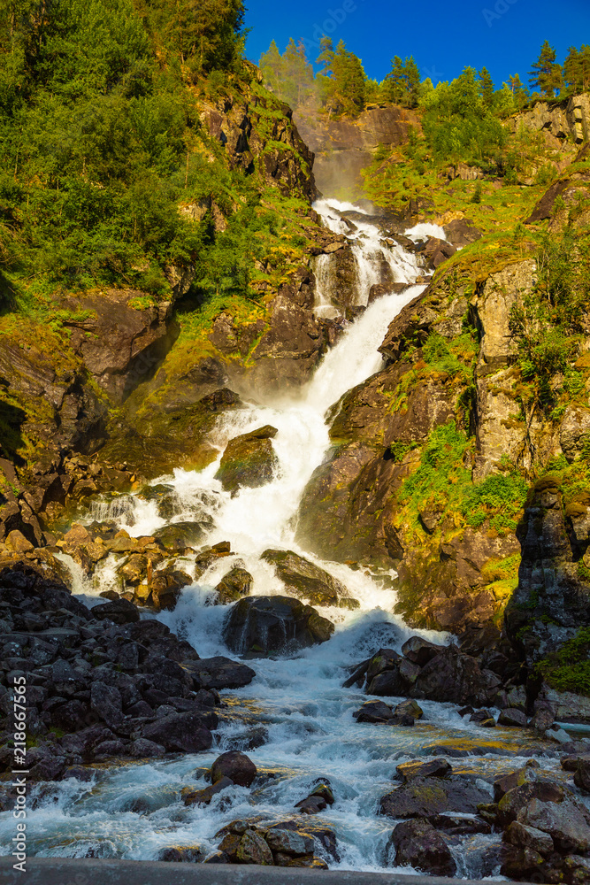 Waterfall Latefossen at sunset lights in summer in Norway