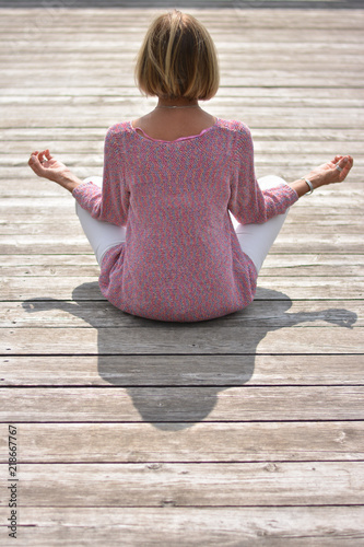 meditating on a wooden footbridge photo