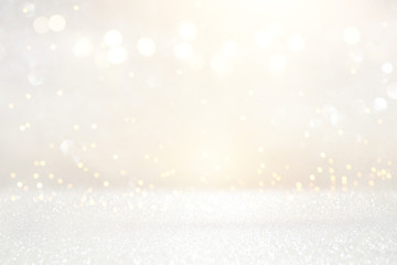 glitter vintage lights background. silver and light gold. de-focused.