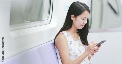 Woman use of mobile phone on train in Taipei city © leungchopan