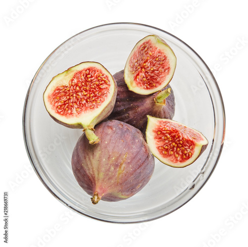 Fresh raw ripe figs in glass bowl isolated on white background. Ingredients for cooking. Top view.
