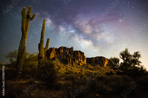 A starry night time desert landscape with the milkyway.  Milkyway rising behind the superstition mountains. Arizona photo