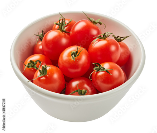 Fresh ripe tomatoes in ceramic bowl isolated on white background with green leaf. Ingredients for cooking. Top view.