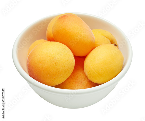 Fresh ripe apricot in ceramic bowl isolated on white background. Ingredients for cooking. Top view.