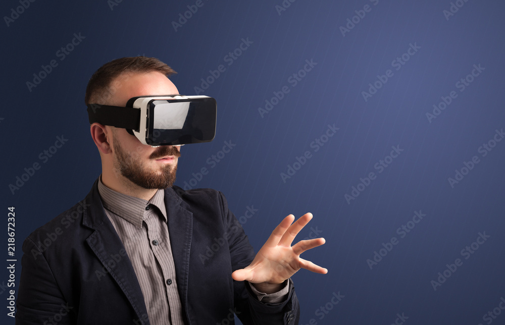 Amazed businessman with virtual reality goggles 