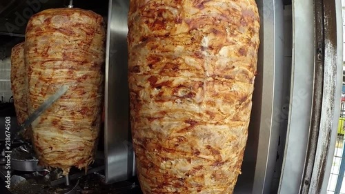 Gyros Preparation in Greek Street Restaurant / A gyro or gyros is a Greek dish made of meat cooked on a vertical rotisserie, traditionally pork, or chicken