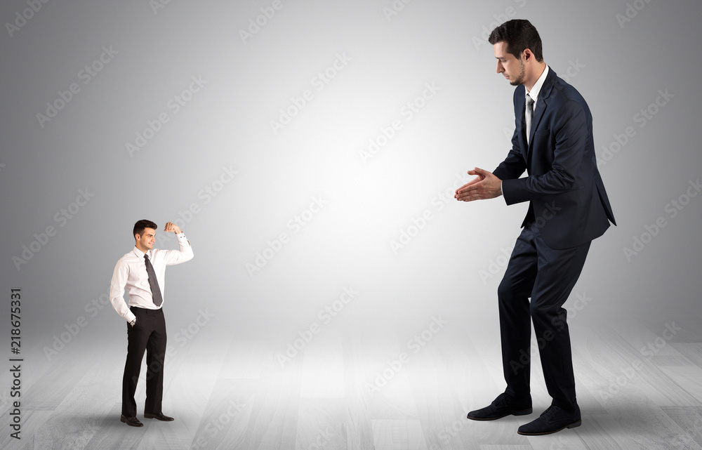 Big debutant young businessman scared of small strong businessman
Big debutant young businessman scared of small strong businessman