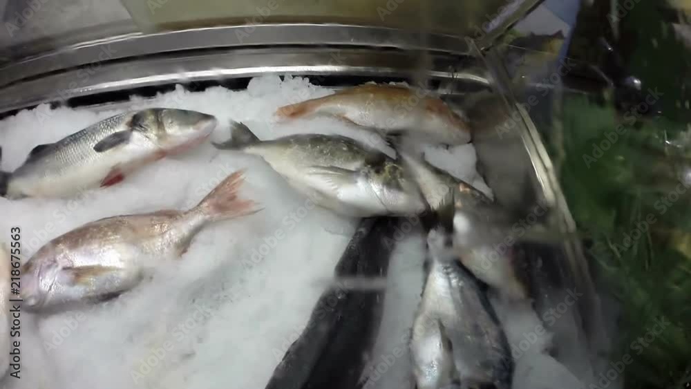 Frozen Sea Fish In Ice / Fresh sea fish on ice at sea food restaurant Frozen Sea Fish In Ice / Fresh sea fish on ice at sea food restaurant
